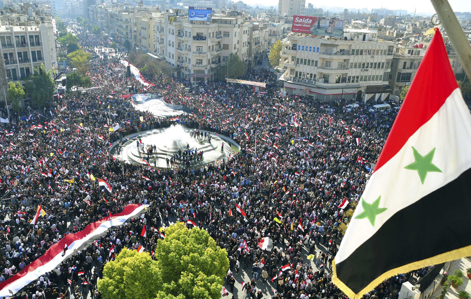 Supporters of Syria's President Bashar al-Assad attend a rally at al-Sabaa Bahrat square in Damascus